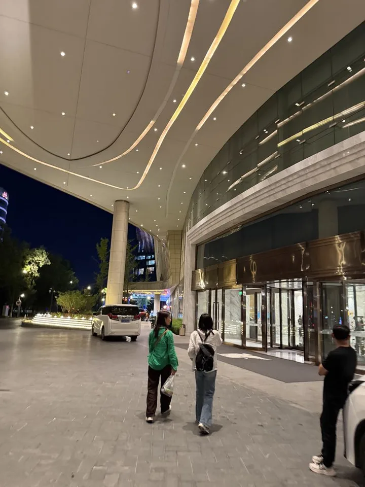 Family walking beneath the illuminated entrance canopy at JW Marriott Hotel Yinchuan
