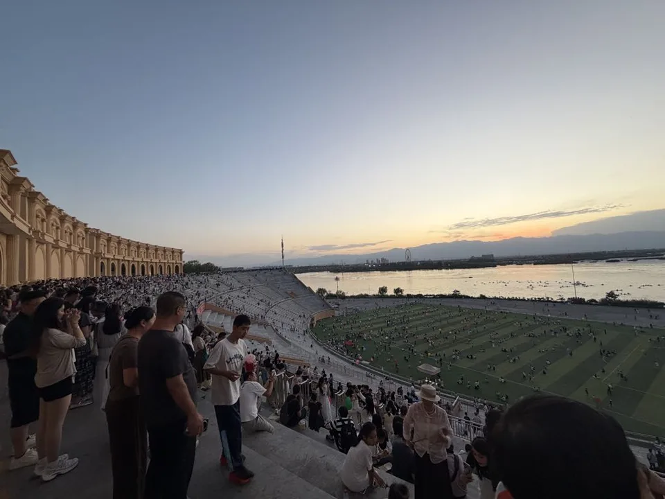 Evening panorama across Lanshan Park amphitheater toward the lake and mountains